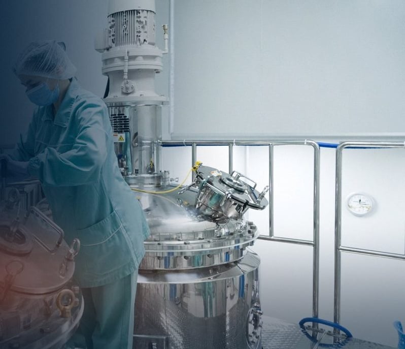 Operator at a stainless-steel reactor in a cleanroom